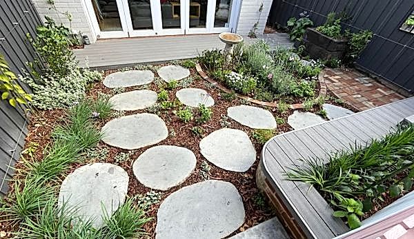 A beautifully landscaped backyard garden with stepping stones in Crows Nest.